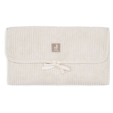 Tapis à langer nomade en tissu côtelé beige avec intérieur feuillage. Léger, pliable et pratique avec poches intégrées. Idéal pour les sorties avec bébé.